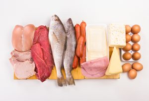Group of important proteins meats fish dairy eggs white meat on a white background Shot from above