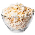 Glass bowl full of popcorn isolated on white background. Popcorn. Bowl of fresh popped popcorn. Bowl of popcorn