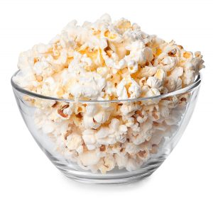 Glass bowl full of popcorn isolated on white background. Popcorn. Bowl of fresh popped popcorn. Bowl of popcorn